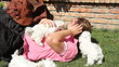 Happy man playing with maltese puppy