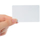 Hand holds business card on white background
