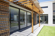 Pergola covering patio of modern house