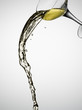 White wine spilling from glass