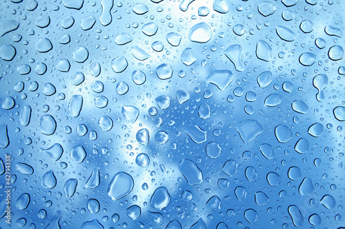 Photo: water drops on glass against blue sky water drops on glass against blue sky