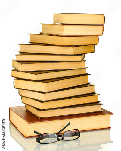 Photo: tower of books with glasses isolated on white background tower of books with glasses isolated on white background