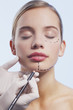 Close up of womanís face being marked with dotted lines