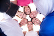 Foto: Young happy friends with heads together in circle Young happy friends with heads together in circle