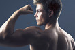 Rear view portrait of man flexing biceps muscles