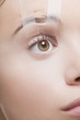 Close up of womanís eye taped open