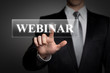 businessman pressing touchscreen button - webinar