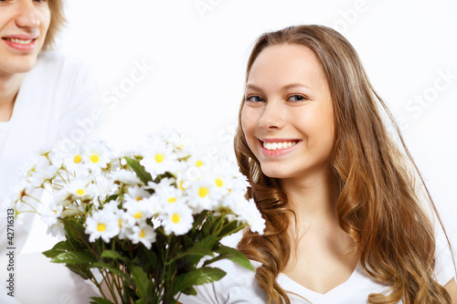 Photo: Young couple at home with present Young couple at home with present