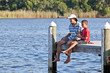 Father and Son Fishing on Wooden Pier