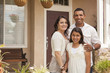 Photo: Small Hispanic Family in Front of Their Home Small Hispanic Family in Front of Their Home