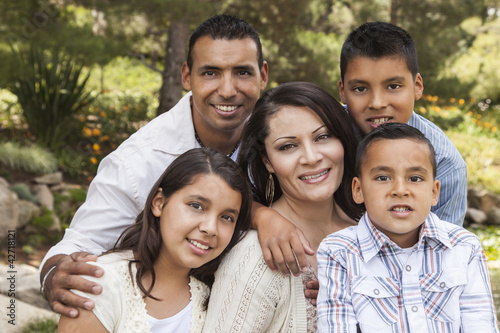 Photo: Happy Attractive Hispanic Family Portrait In the Park Happy Attractive Hispanic Family Portrait In the Park