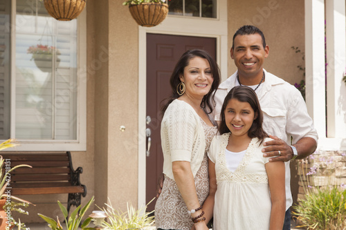 Photo: Small Hispanic Family in Front of Their Home Small Hispanic Family in Front of Their Home