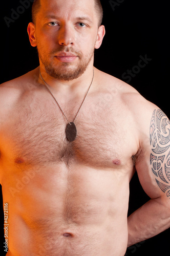 Photo: Portrait of an adult shirtless soldier with dog tags Portrait of an adult shirtless soldier with dog tags