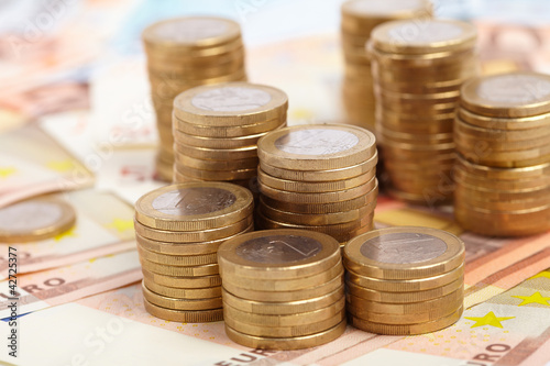 Photo: Euro coins on banknote money background Euro coins on banknote money background