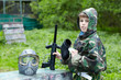 Boy in camouflage with removed protective mask