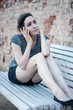 Unhappy young woman crying while talking on the phone