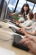 Student & Teacher Using Computers at College