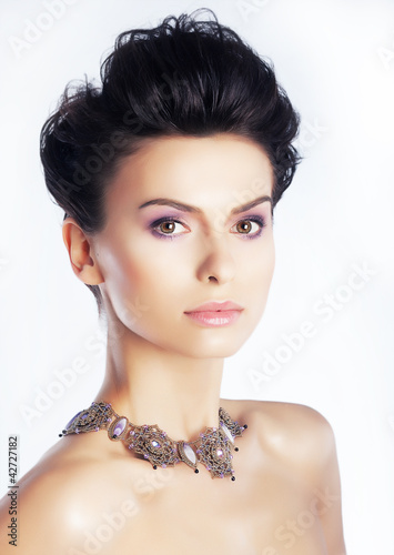 Photo: Beauty model with natural makeup, clean skin. White background Beauty model with natural makeup, clean skin. White background