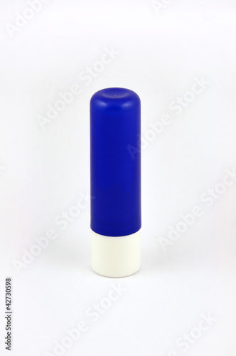 Photo: Blue tube of lip balm isolated on white background Blue tube of lip balm isolated on white background