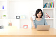 a young asian woman using laptop computer