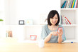 a young asian woman using smart phone