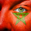 Flag painted on face with green eye to show morocco support