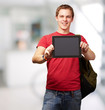 portrait of young man holding a digital tablet indoor