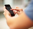 Young man touching a modern mobile, closeup