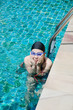 Close up woman swimming in swimming pool.