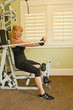 Caucasian woman using exercise machine