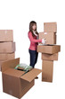 young girl packing up and moving - isolated