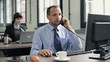 Young businessman talking on telephone in the office