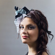 Portrait of the young  girl in hat with veil.