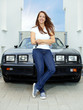 Foto: Pretty woman proudly presents the key of her antique car Pretty woman proudly presents the key of her antique car