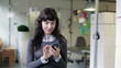 Young businesswoman with smartphone in the office