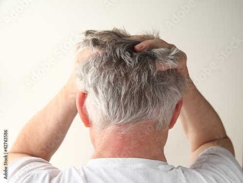 Photo: rear view of a man showing negative feelings rear view of a man showing negative feelings