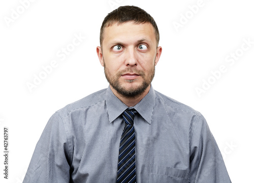 Photo: Funny bearded businessman makes funny eyes on white Funny bearded businessman makes funny eyes on white