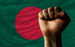 Hard fist in front of bangladesh flag symbolizing power