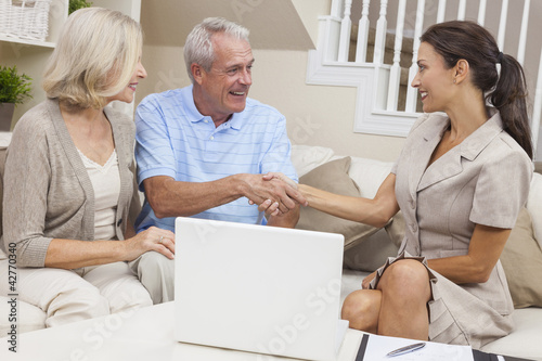 Photo: Saleswoman Shaking Hands With Senior Couple at Home Saleswoman Shaking Hands With Senior Couple at Home