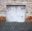 old roll up garage door on brick wall