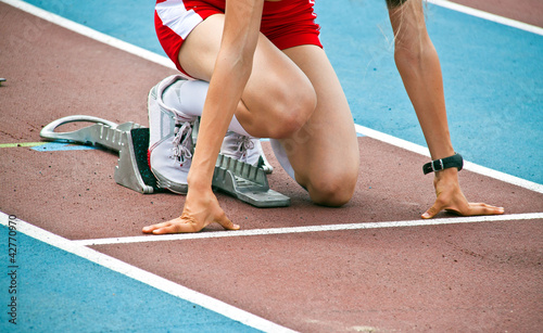 Photo: Female athlet in a starting block Female athlet in a starting block