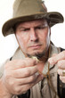 Fly fisherman threading line through hook.
