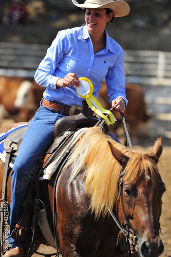 Photo: Cowgirl gets a medal for winning the competition Cowgirl gets a medal for winning the competition