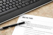 Closeup of Resume with Pen and Keyboard on the Table