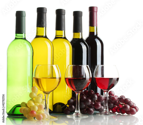 Photo: bottles and glasses of wine and ripe grapes isolated on white bottles and glasses of wine and ripe grapes isolated on white