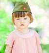 Cute little girl in a soldier's caps