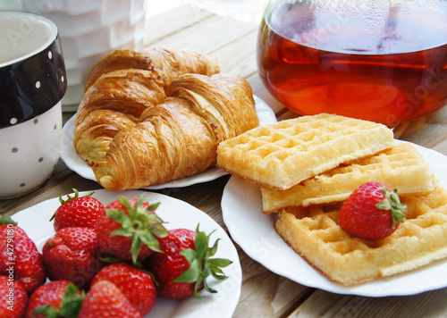 Photo: Tasty breakfast - tea, croissants, wafers with cream Tasty breakfast - tea, croissants, wafers with cream