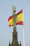 Photo: Spanish flag waves behind statue of Christopher Columbus, Plaza de Col—n in Madrid, Spain Spanish flag waves behind statue of Christopher Columbus, Plaza de Col—n in Madrid, Spain