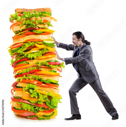 Photo: Man and giant sandwich on white Man and giant sandwich on white