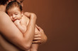 Newborn baby sleeping on the shoulder of his father